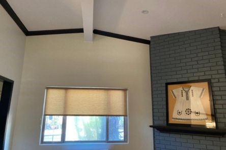 Custom pull down window shades partially closed in bright El Cajon living room for light control.