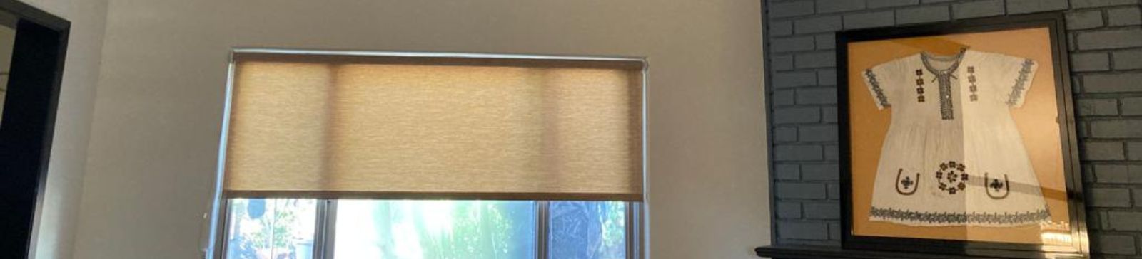 Custom pull down window shades partially closed in bright El Cajon living room for light control.
