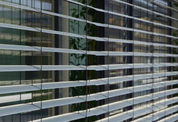 Detail of mini blinds installed in a cozy home environment, enhancing privacy and style.