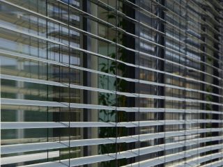 Detail of mini blinds installed in a cozy home environment, enhancing privacy and style.